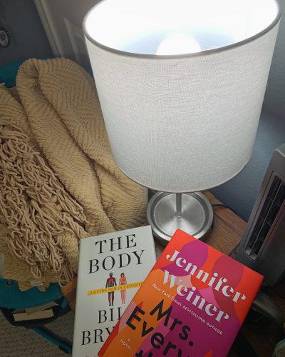 Books underneath a bedside lamp using the NorbSLEEP wellness LED bulb